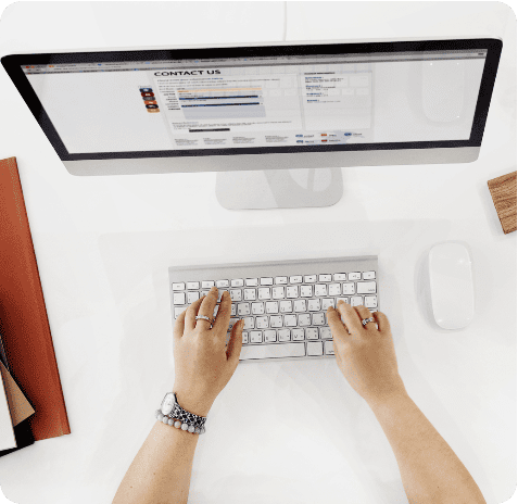 aerial-view-hands-working-computer-white-table-office